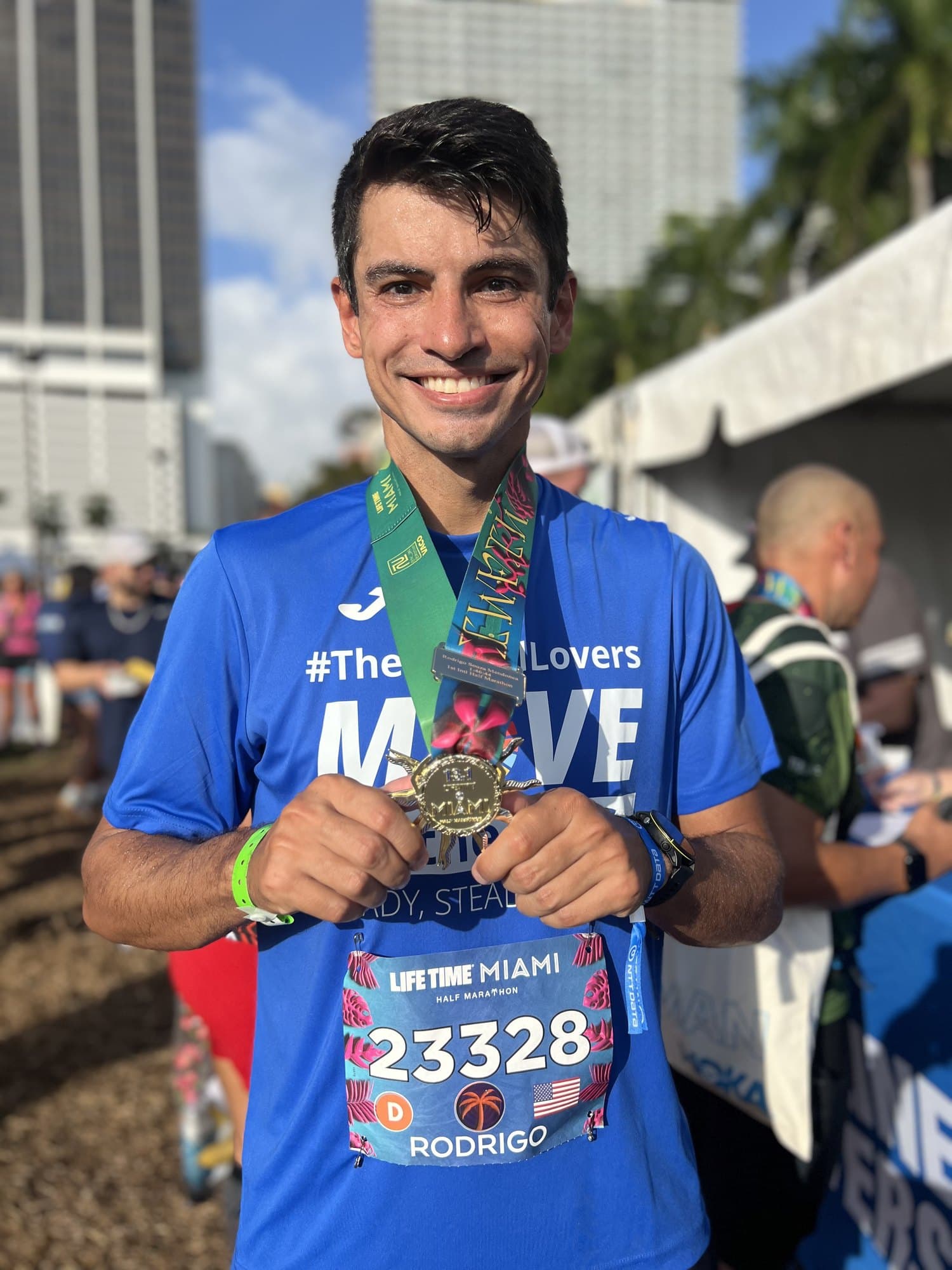 A Miami Marathon finisher celebrating with a freshly engraved medal